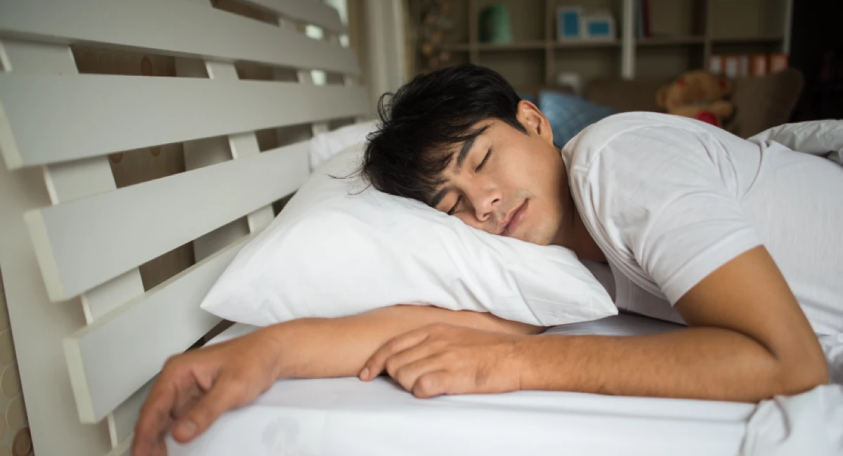 man sleeping on bed 