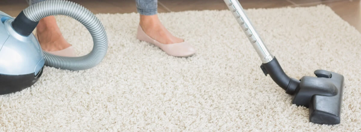 Woman hoovering floor