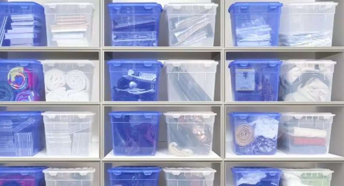 wall of sealed plastic storage bins with clothes and other items stored
