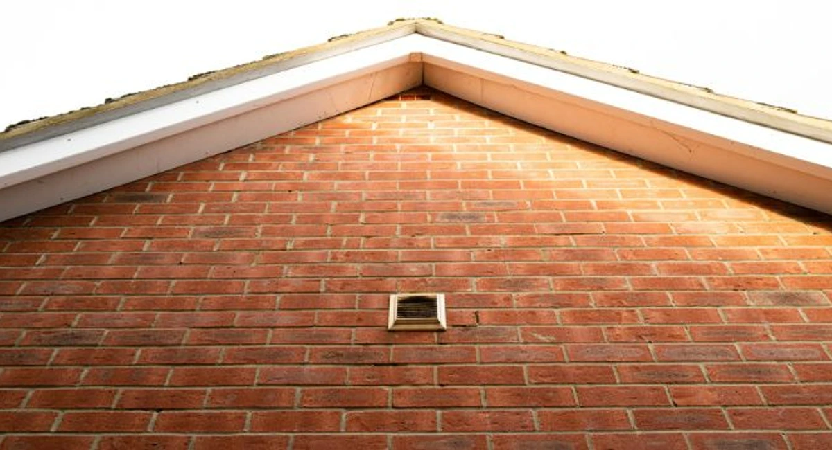 air vent on the side of a red brick house