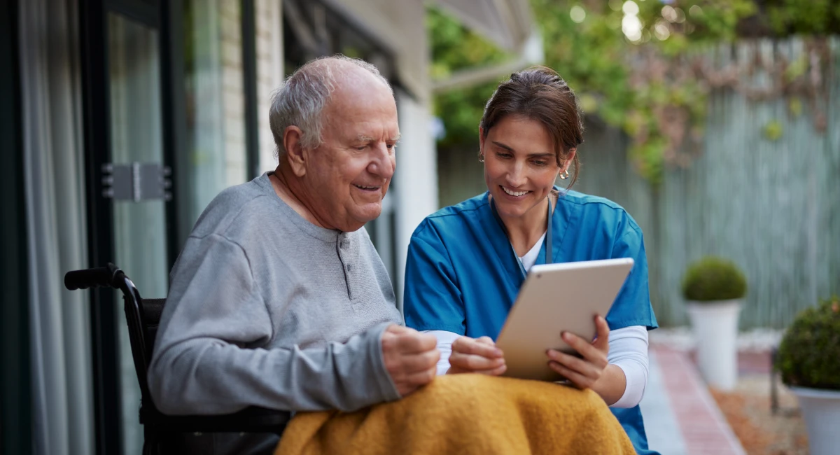 A nursing assistant helping an elderly resident