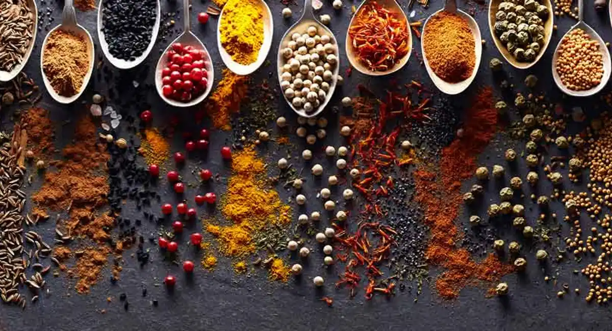 spoons with different spices leaving a trail of each spice 