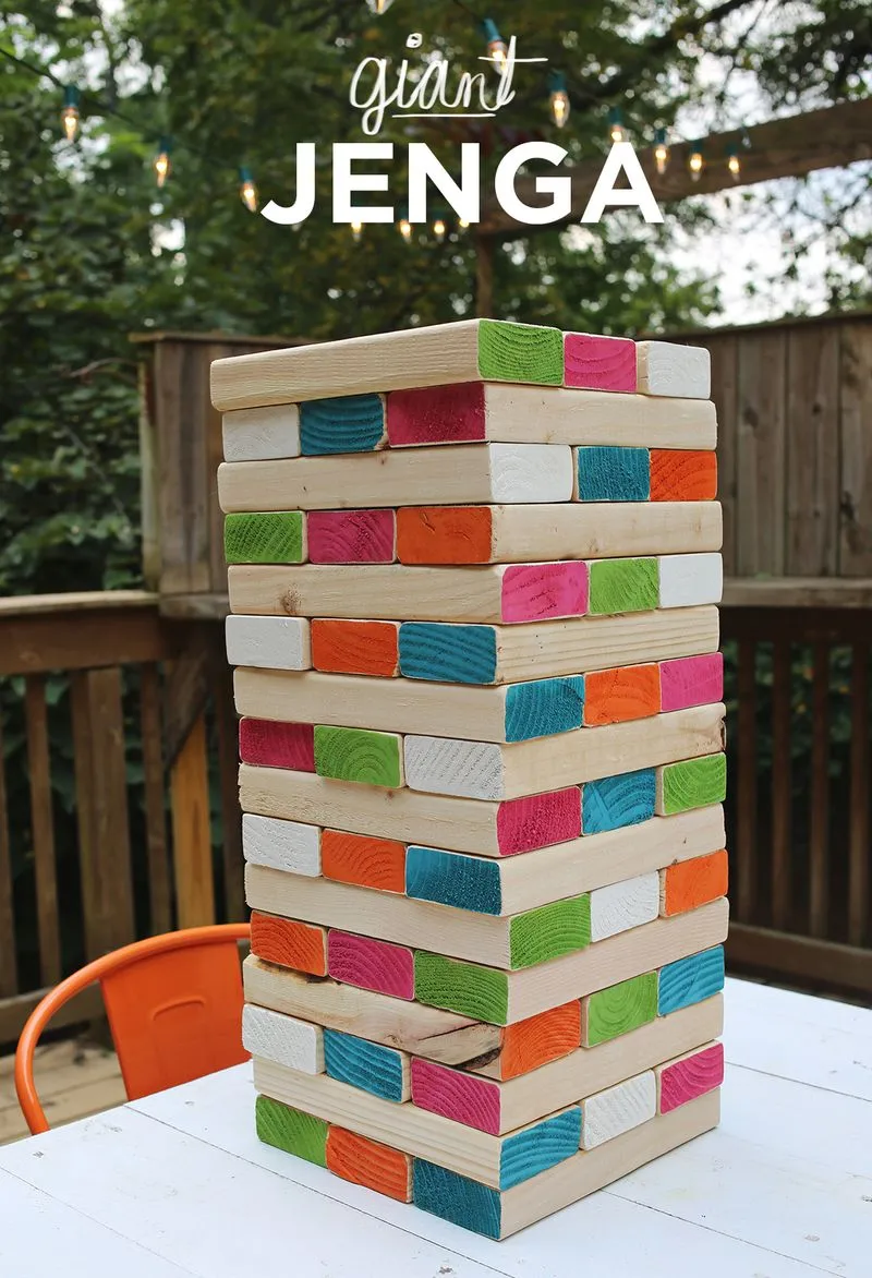 Giant jenga on outdoor table with colored and wood blocks